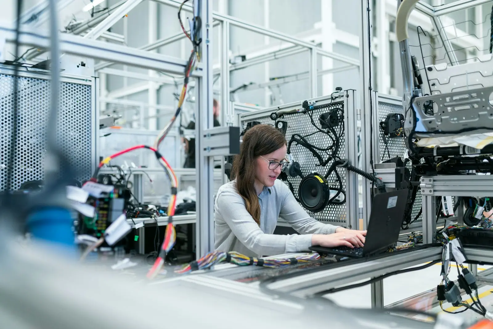 Engineer commissioning PLC control logic on a production line